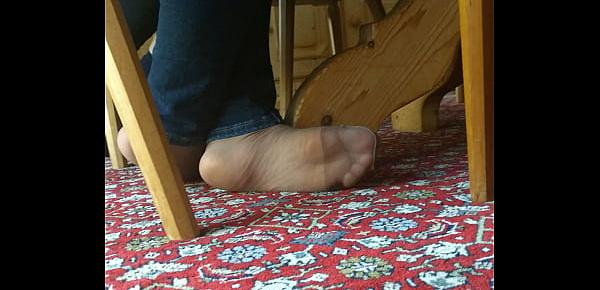  my girlfriend is resting her feet in tan nylons